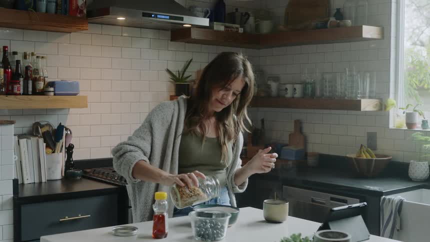 A woman fills a bowl
