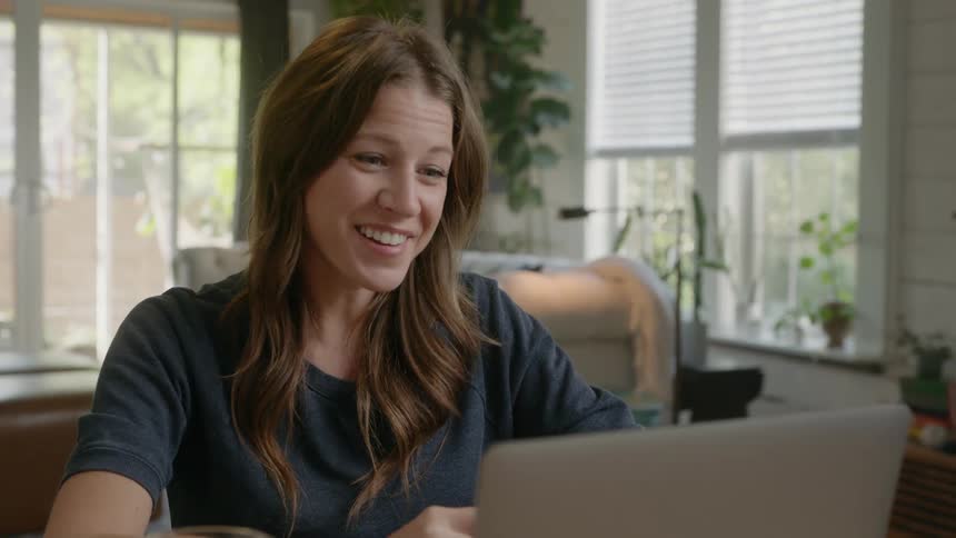 A woman talks to her laptop