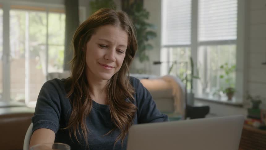A woman works on her computer