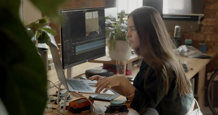 A woman works on laptop