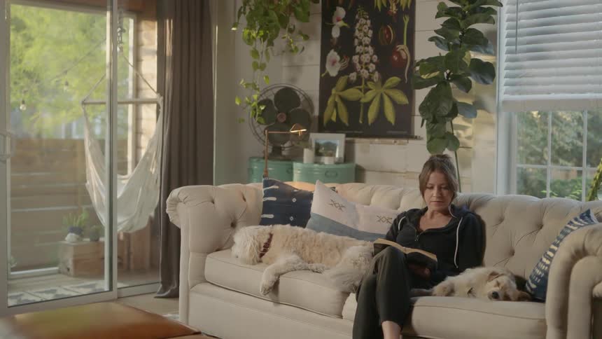 A woman reads on the couch