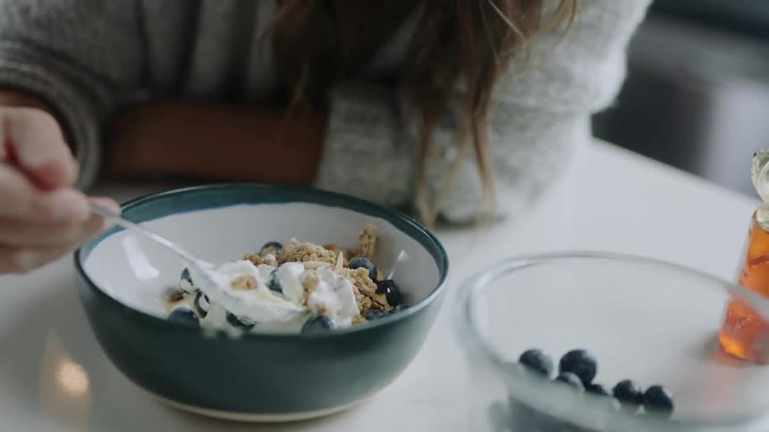 A woman eating breakfast cereal