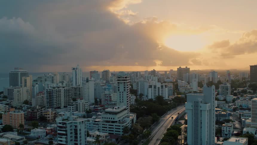 The skyline of a crowded city is seen underneath a cloudy sky