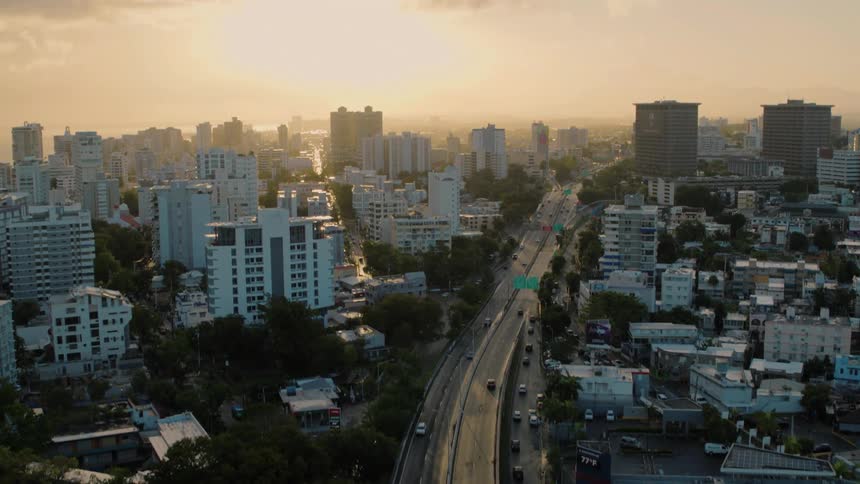 Vehicles travel down the freeway through the city