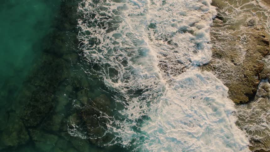 Waves crash onto rocks in the ocean