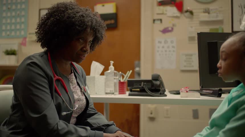 A nurse talking to a girl in a clinic