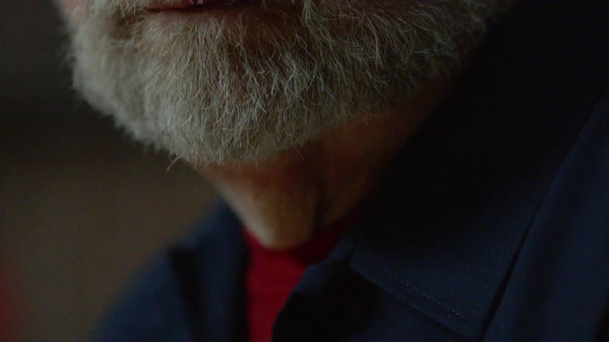 Man with a gray beard remains still