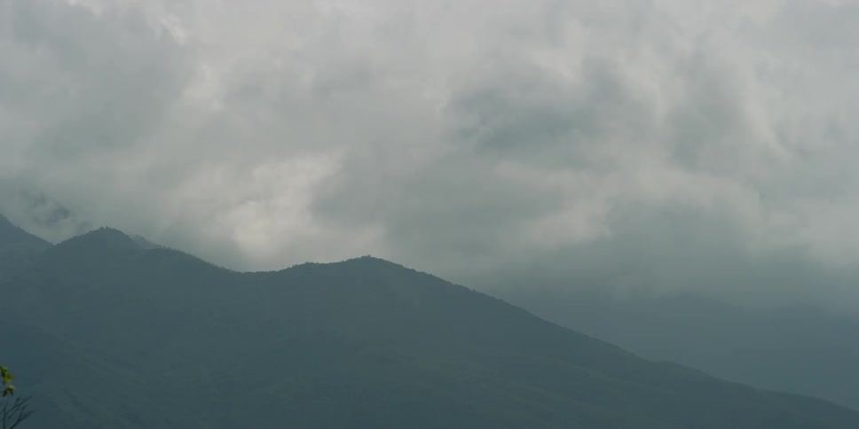 A mountain with the sky in the background