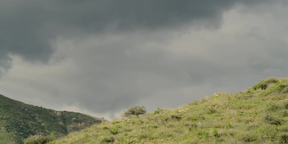 Dark clouds rolling in over hills