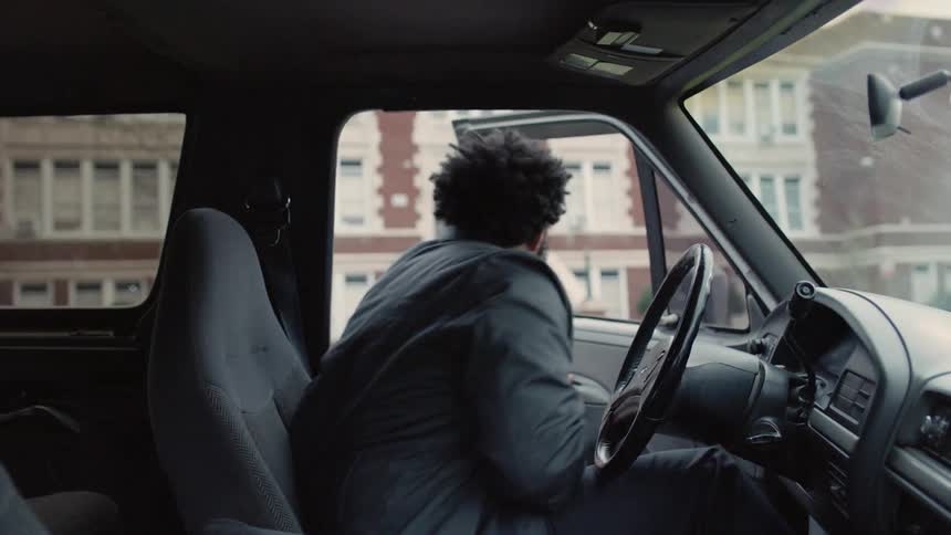 Man parks car then gets out before walking toward building
