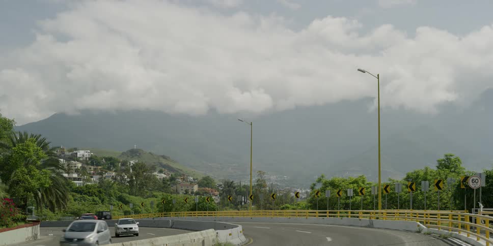 The cars go around the bend on the highway