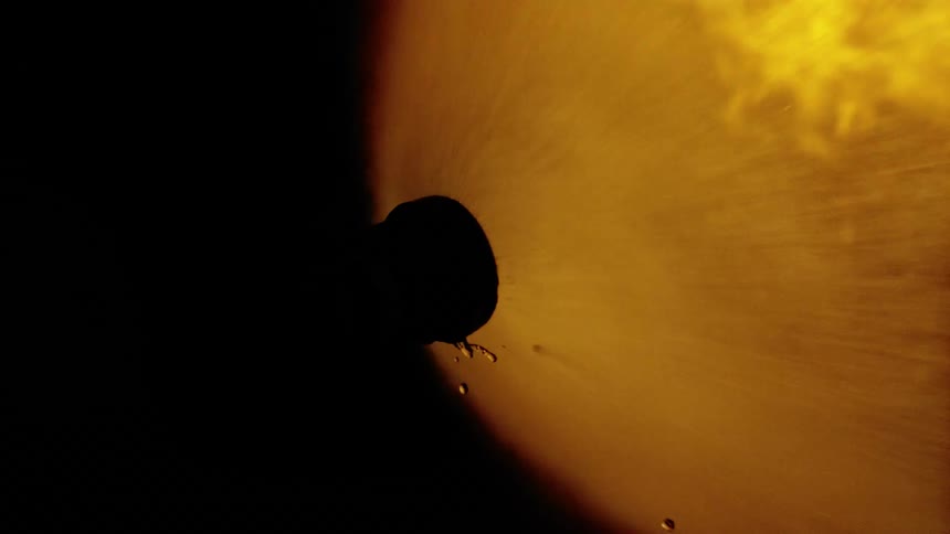 Water flows under high pressure from firehouse into flames