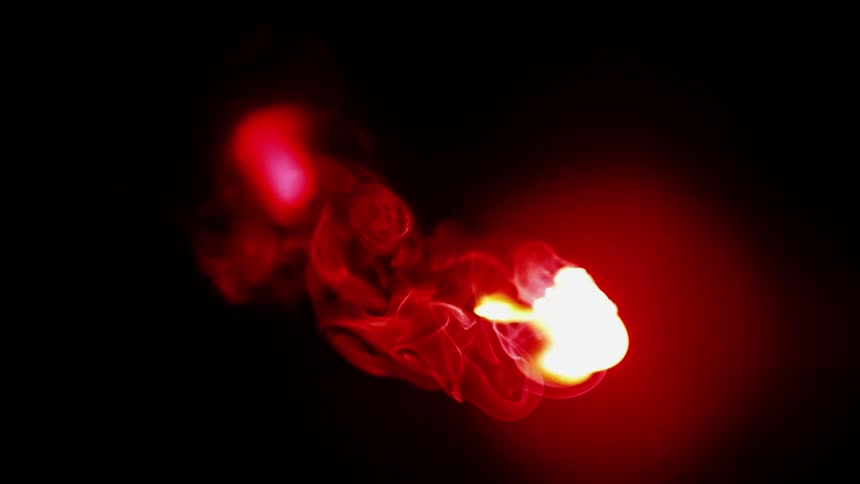 A fire is smoking in the dark