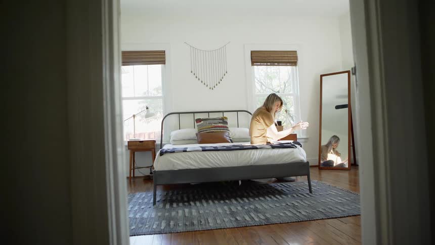 A woman sits in bed