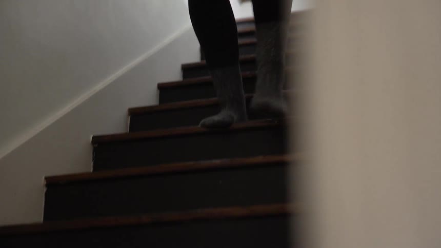 A woman runs down the stairs