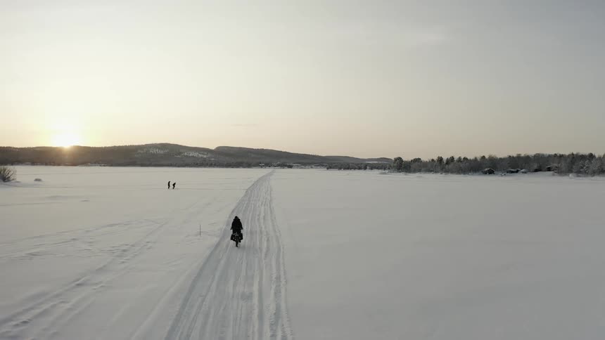 A person riding a bicycle in the snow