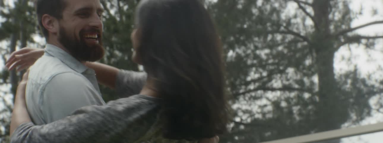 A man carries a woman around outside