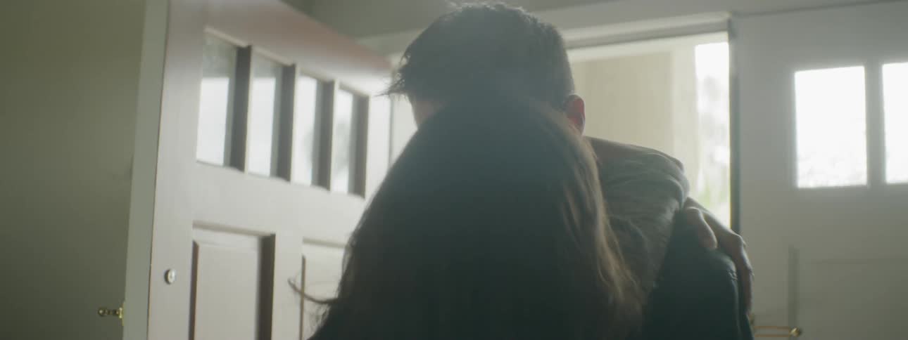 A white man and an indian couple embrace and kiss