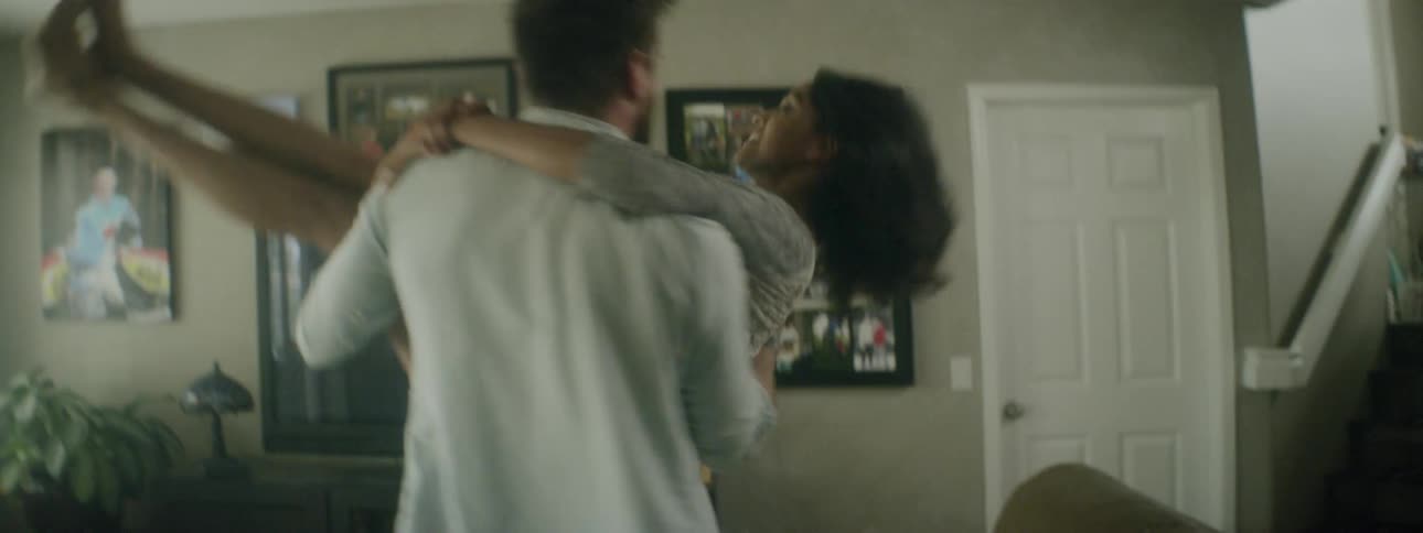Man carries woman around playfully
