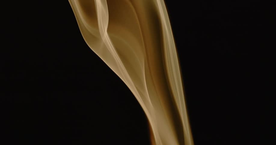 Smoke rises up on a black background
