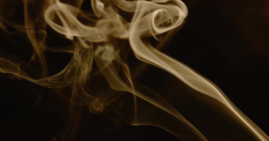 Against a dark background wisps of smoke rise upwards