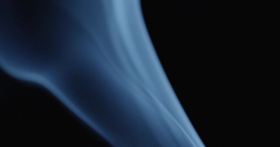 Close up view of blue smoke against black background