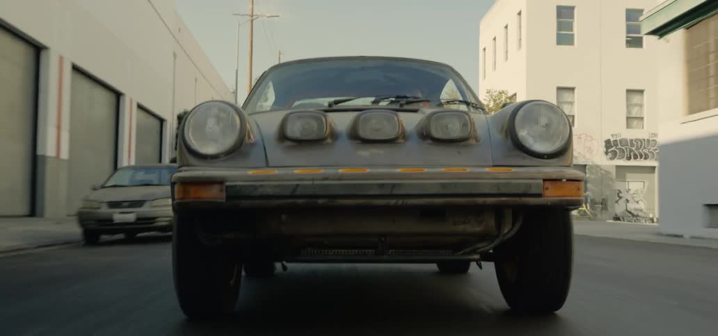 A car speeds down an urban street