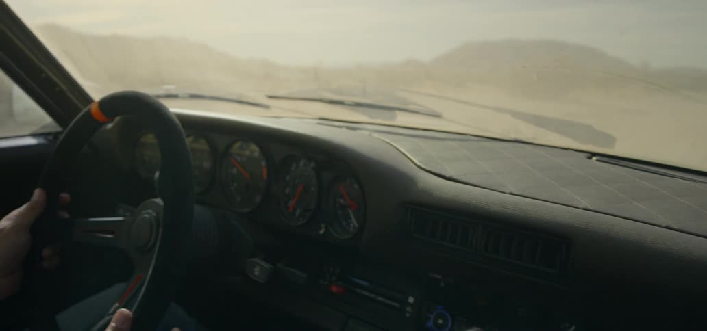 Man driving sports car on a desert