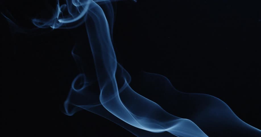 Smoke that is billowing in a black room