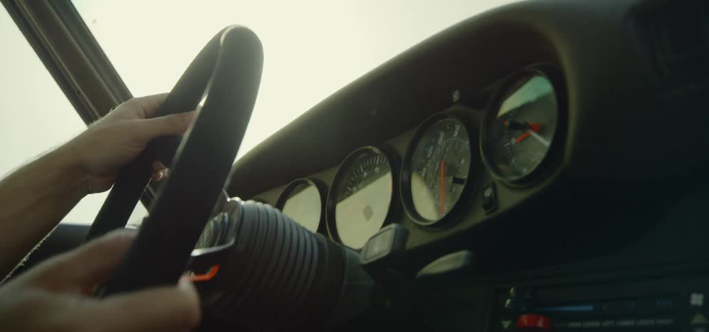 A person turns the steering wheel of a vehicle