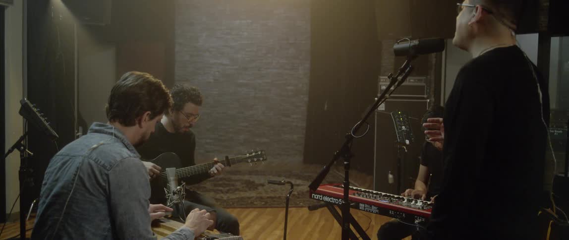 A band plays a song in a recording studio
