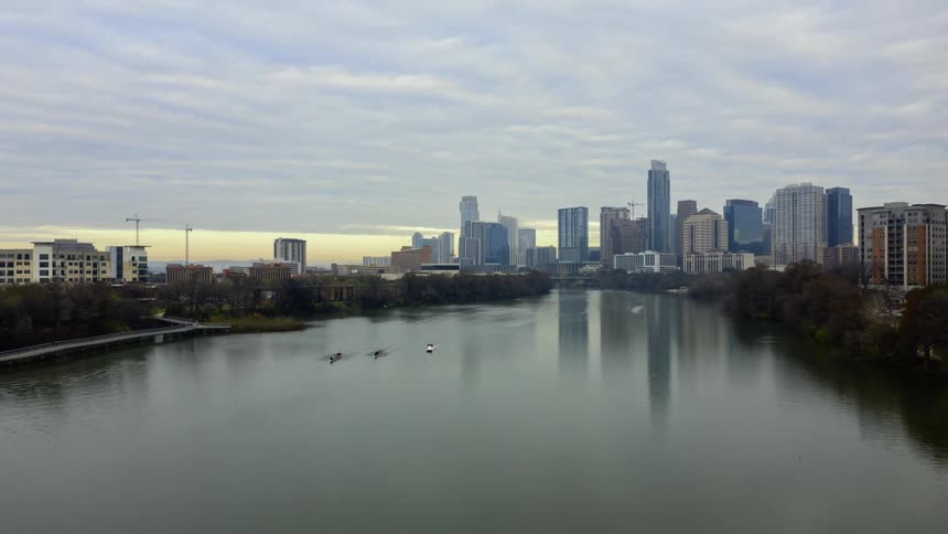 Under a cloudy sky a large city is located along the banks of a wide river