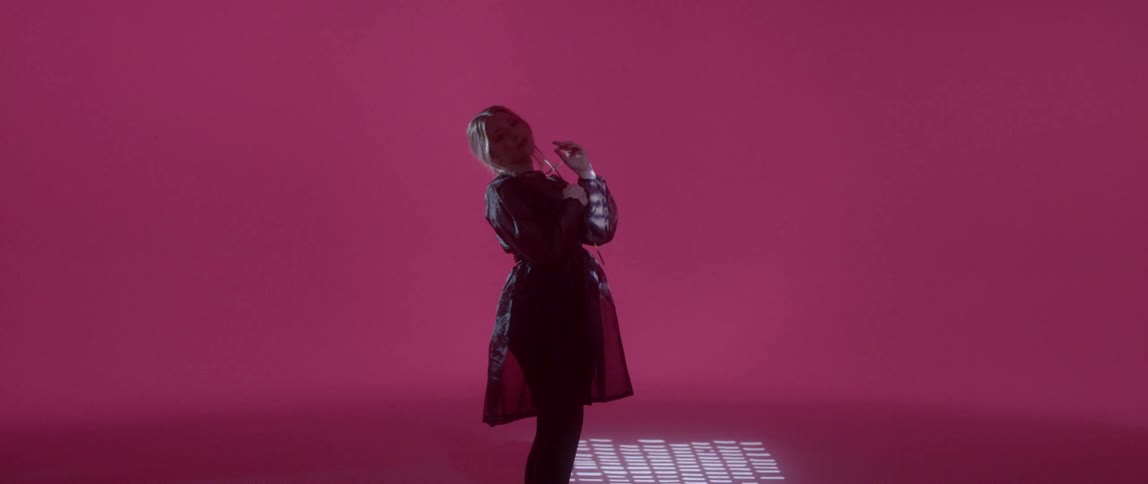 Woman dressed in black leans backwards