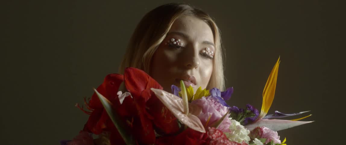 A woman with flowers and beads eyeshadow