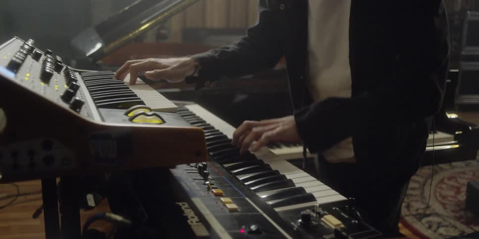 Man rocking out on keyboard in a home studio