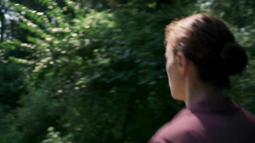A woman jogs to the vehicle