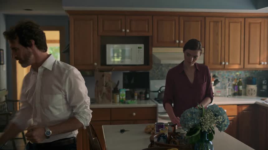 A woman and a man in a kitchen