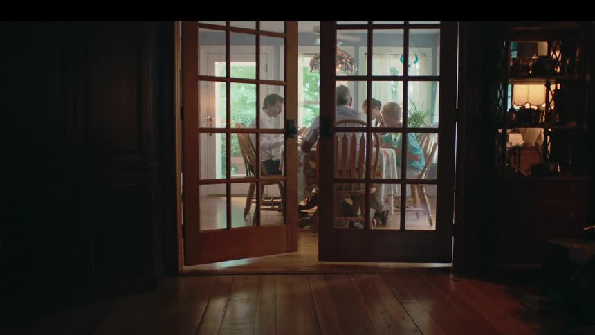 People sitting at a dinner table eating