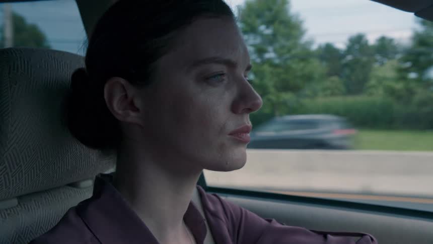 A woman in a car driving