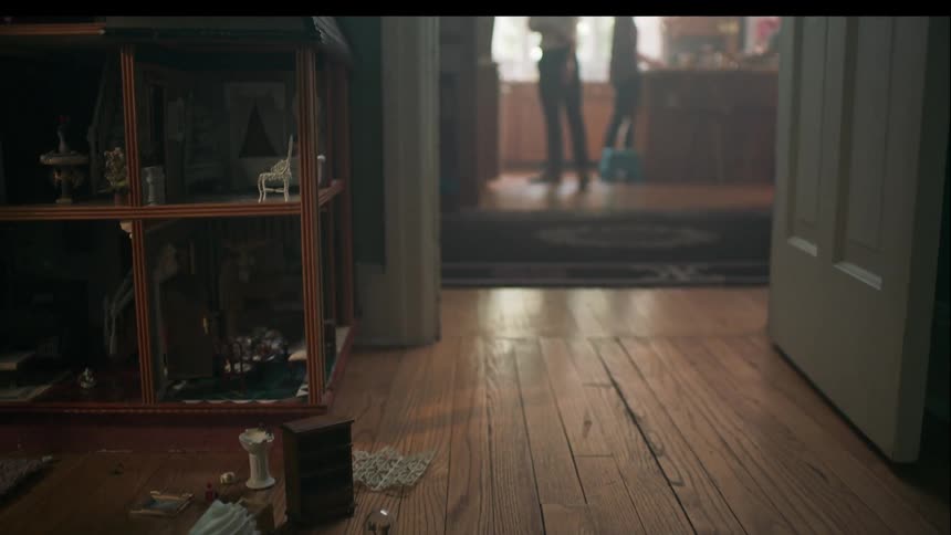 A child runs out of her bedroom and dad walks over to the kitchen doorway to see whats up