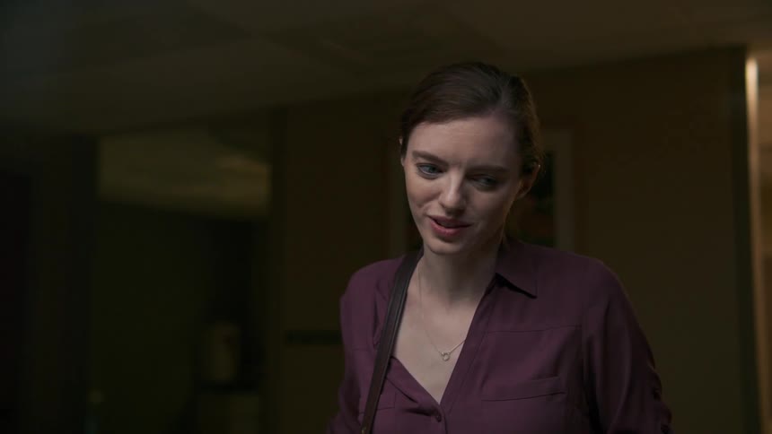 A woman closes her eyes while talking to someone