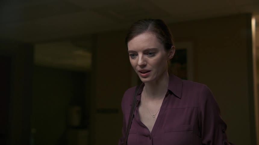 A woman shakes her head as she talks