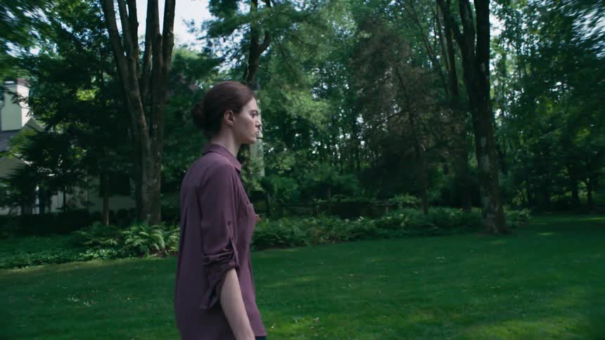 A woman walks to her house