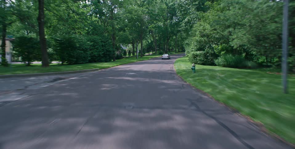 A vehicle traveling through a suburban neighborhood