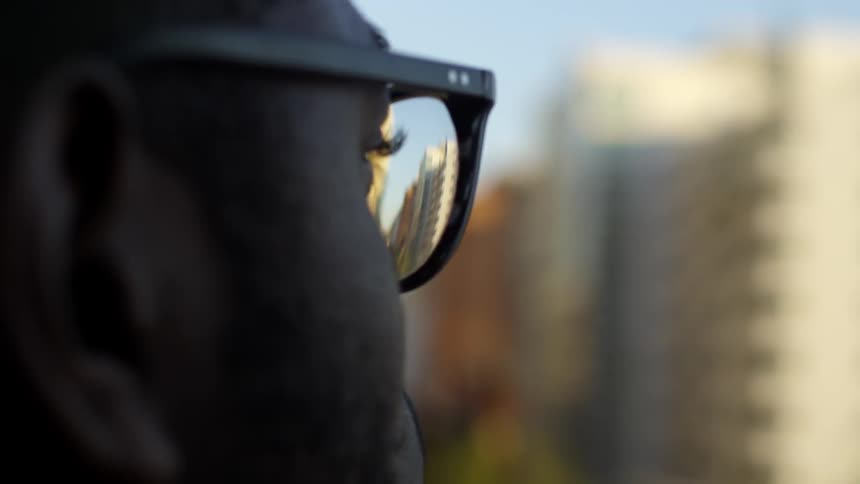 A man stares out at some buildings