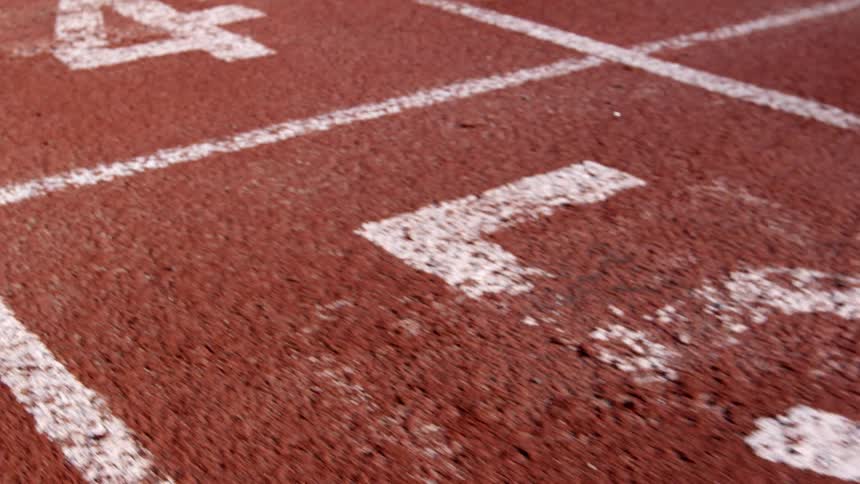 Camera pans over runner's track
