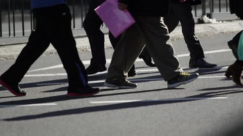 Pedestrians cross a city street