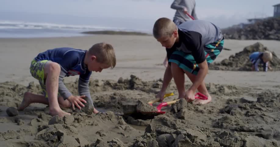 Children play in the sand on a beach