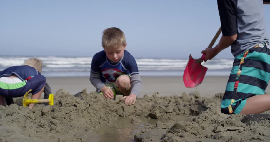 A group of kids play on the beach