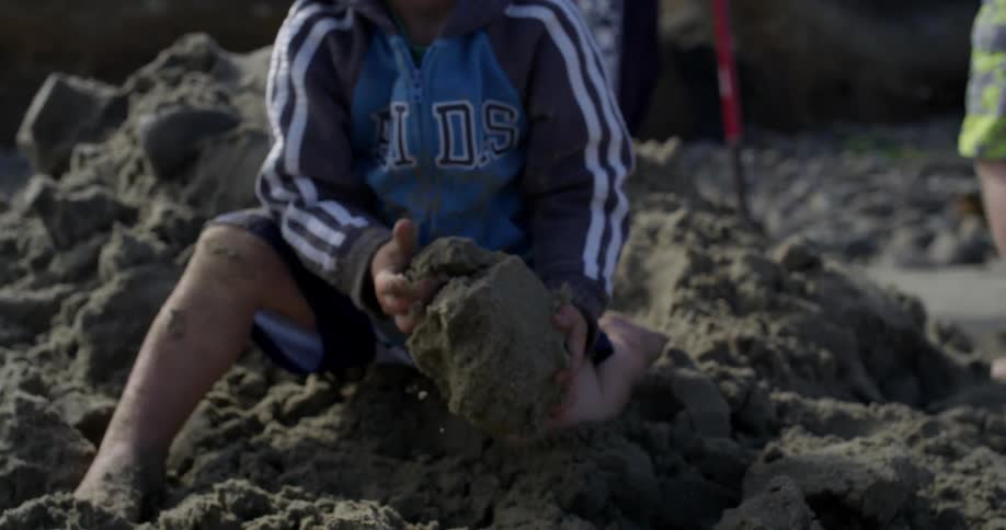 Children are playing around in the sand